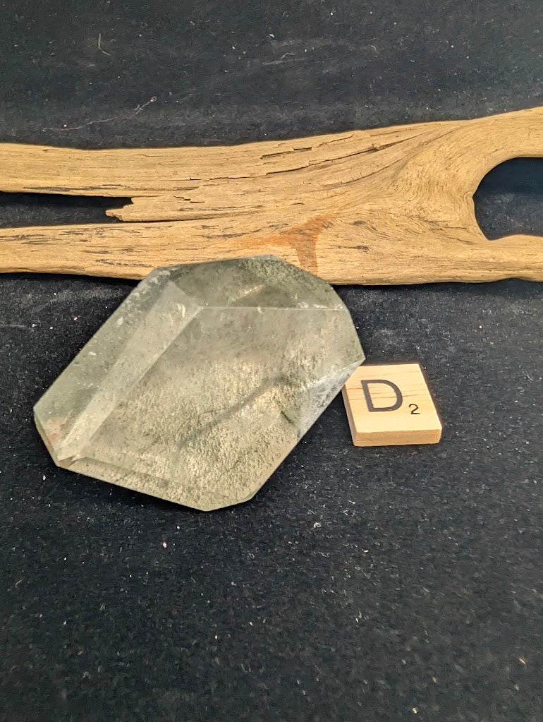 Exact piece Garden Quartz faceted freeform, Variant D2, showcasing high clarity quartz with a sweeping, prominent green chlorite landscape inclusion.