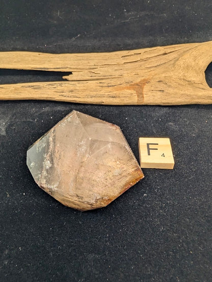 Exact piece Garden Quartz faceted freeform, Variant F4, displaying dense, terraced layers of reddish-brown iron oxide inclusions.