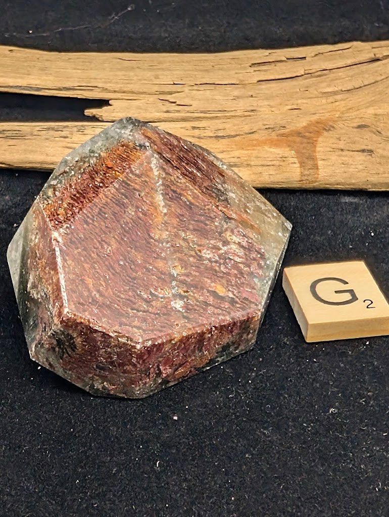Angled view of exact piece Garden Quartz faceted freeform, Variant G2, showing the depth of the textured mineral landscape.