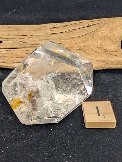 Exact piece Garden Quartz faceted freeform, Variant I1, displaying exceptional clarity with delicate, floating golden-yellow and white mineral wisps.