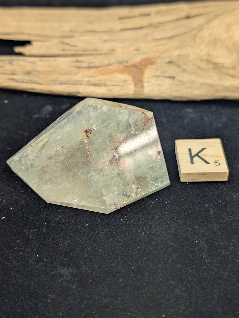 Exact piece Garden Quartz chunky freeform, featuring a highly concentrated central cluster of dark and reddish-brown minerals.