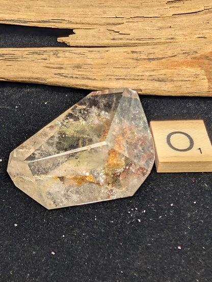 Exact piece Garden Quartz wide freeform, dominated by a striking, dense reddish-brown iron oxide structure cutting diagonally.