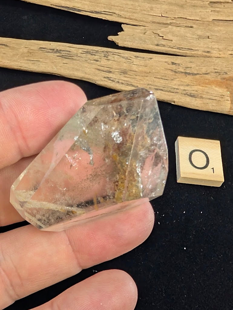 Exact piece Garden Quartz wide freeform, dominated by a striking, dense reddish-brown iron oxide structure cutting diagonally.