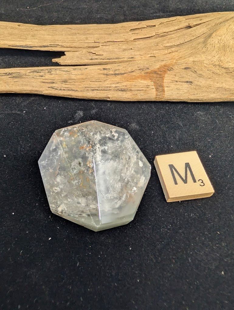 Exact piece Garden Quartz geometric faceted freeform, featuring a highly transparent matrix with delicate red and green floating inclusions.