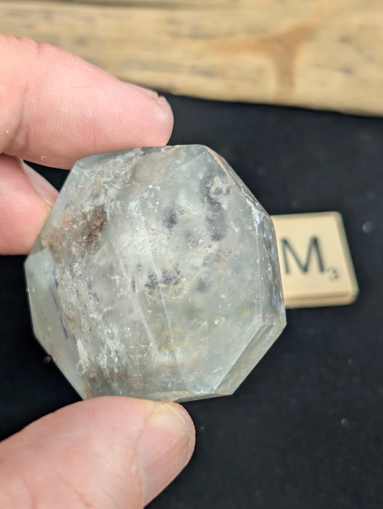 Exact piece Garden Quartz geometric faceted freeform, featuring a highly transparent matrix with delicate red and green floating inclusions.