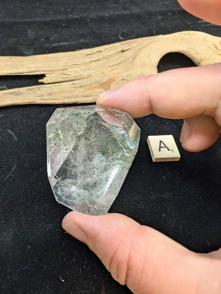 Exact piece Garden Quartz faceted freeform, showcasing delicate green chlorite moss-like inclusions within clear quartz.