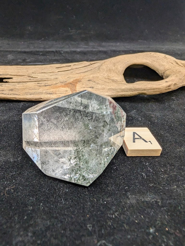 Exact piece Garden Quartz faceted freeform, showcasing delicate green chlorite moss-like inclusions within clear quartz.