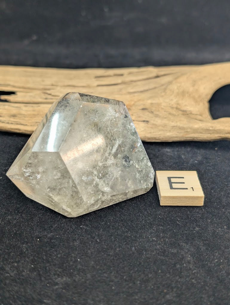 Exact piece Garden Quartz faceted freeform, featuring striking layered horizontal bands of green and red mineral inclusions.