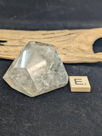 Exact piece Garden Quartz faceted freeform, featuring striking layered horizontal bands of green and red mineral inclusions.