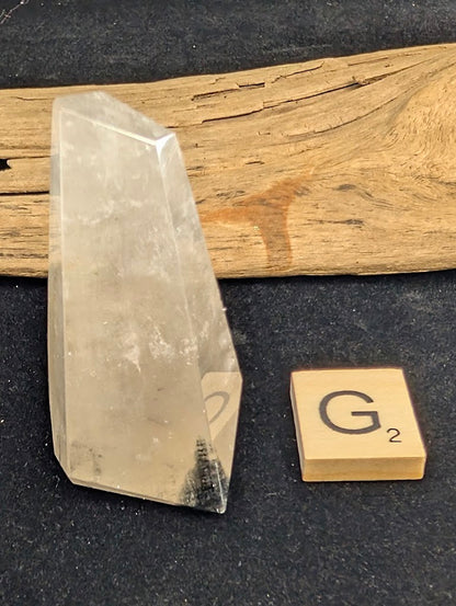 Exact piece Garden Quartz faceted freeform, highly transparent with delicate, sparse pinkish-red and green suspended wisps.