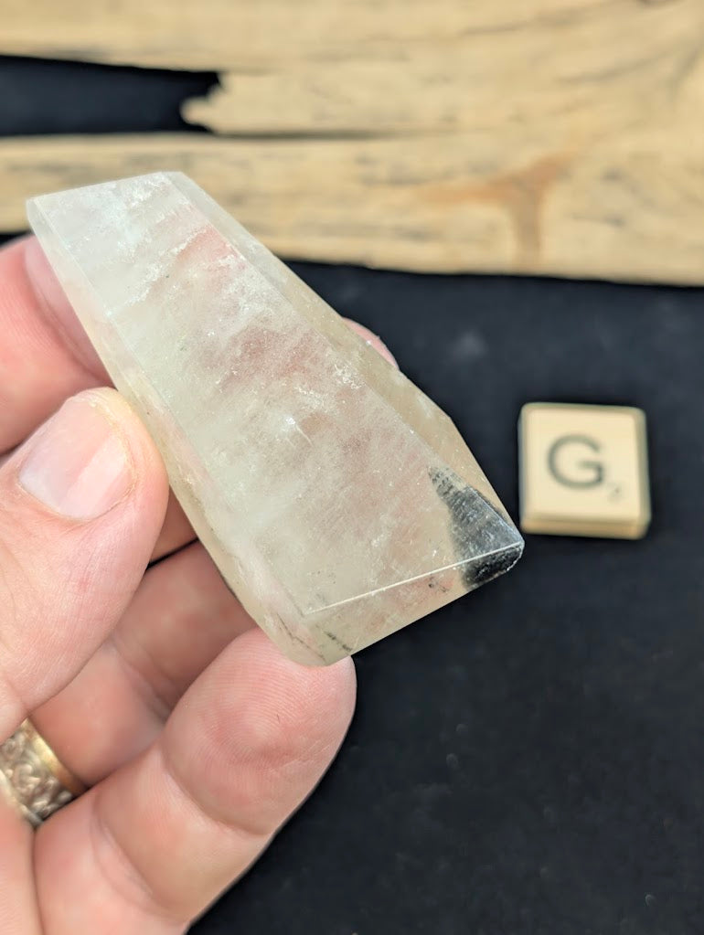 Exact piece Garden Quartz faceted freeform, highly transparent with delicate, sparse pinkish-red and green suspended wisps.