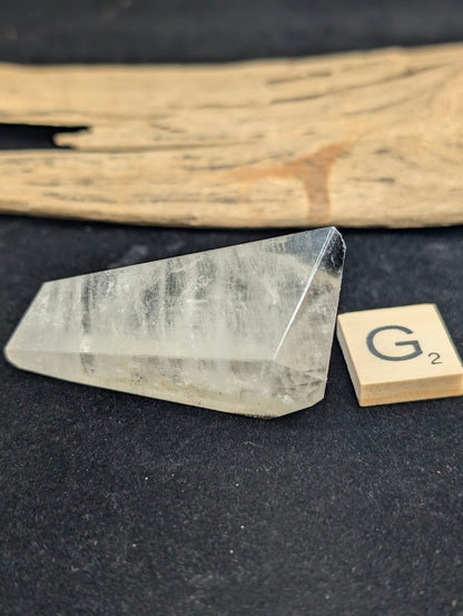Exact piece Garden Quartz faceted freeform, highly transparent with delicate, sparse pinkish-red and green suspended wisps.