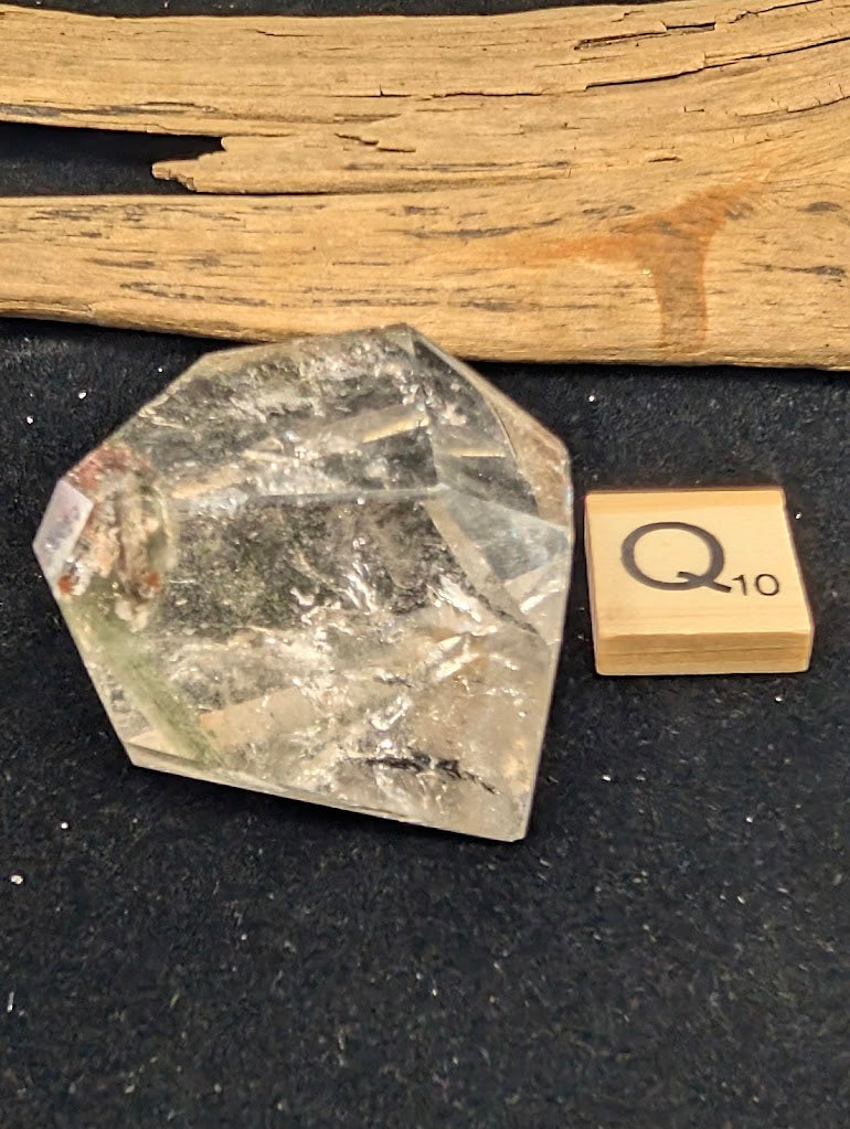 Exact piece Garden Quartz steep point freeform, featuring high clarity and a distinct deep red tubular inclusion near the base.