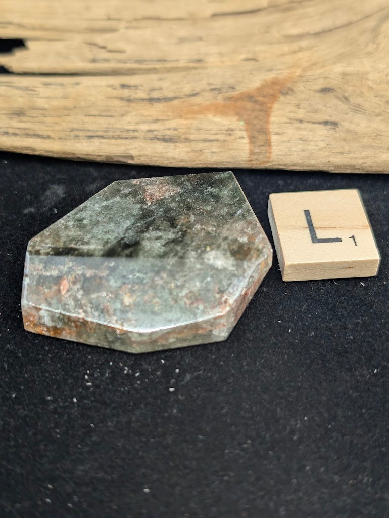 Exact piece Garden Quartz broad wedge, displaying dense, sweeping horizontal green chlorite bands framed by rusty red edges.