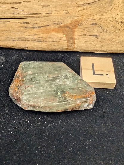 Exact piece Garden Quartz broad wedge, displaying dense, sweeping horizontal green chlorite bands framed by rusty red edges.