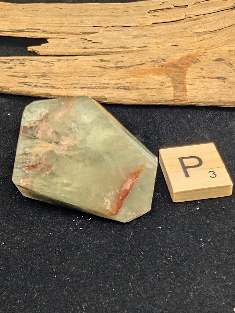 Exact piece Garden Quartz tabular freeform, heavily included with horizontal layers of red iron oxide and green chlorite.