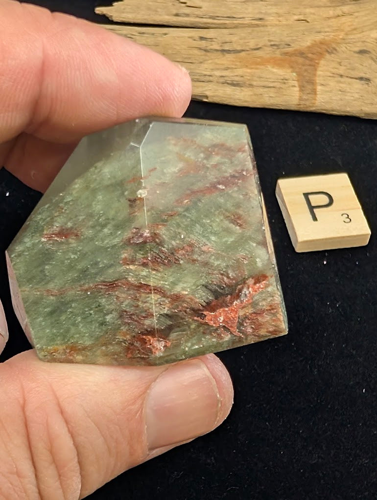 Exact piece Garden Quartz tabular freeform, heavily included with horizontal layers of red iron oxide and green chlorite.