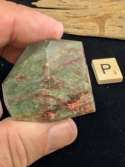 Exact piece Garden Quartz tabular freeform, heavily included with horizontal layers of red iron oxide and green chlorite.