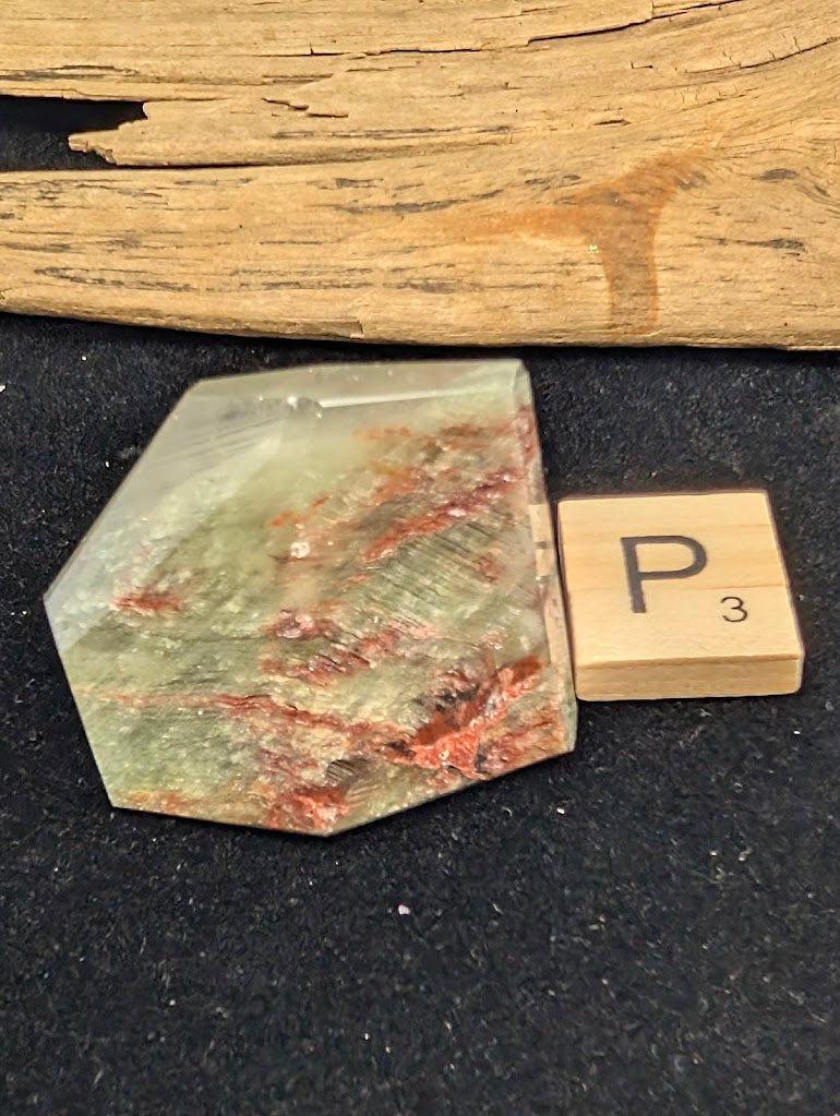 Exact piece Garden Quartz tabular freeform, heavily included with horizontal layers of red iron oxide and green chlorite.