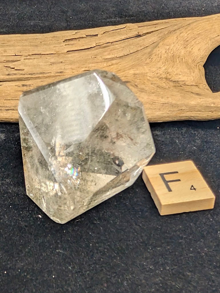Exact piece Garden Quartz faceted tapered wedge, featuring a single highly concentrated dark green chlorite inclusion at the base.
