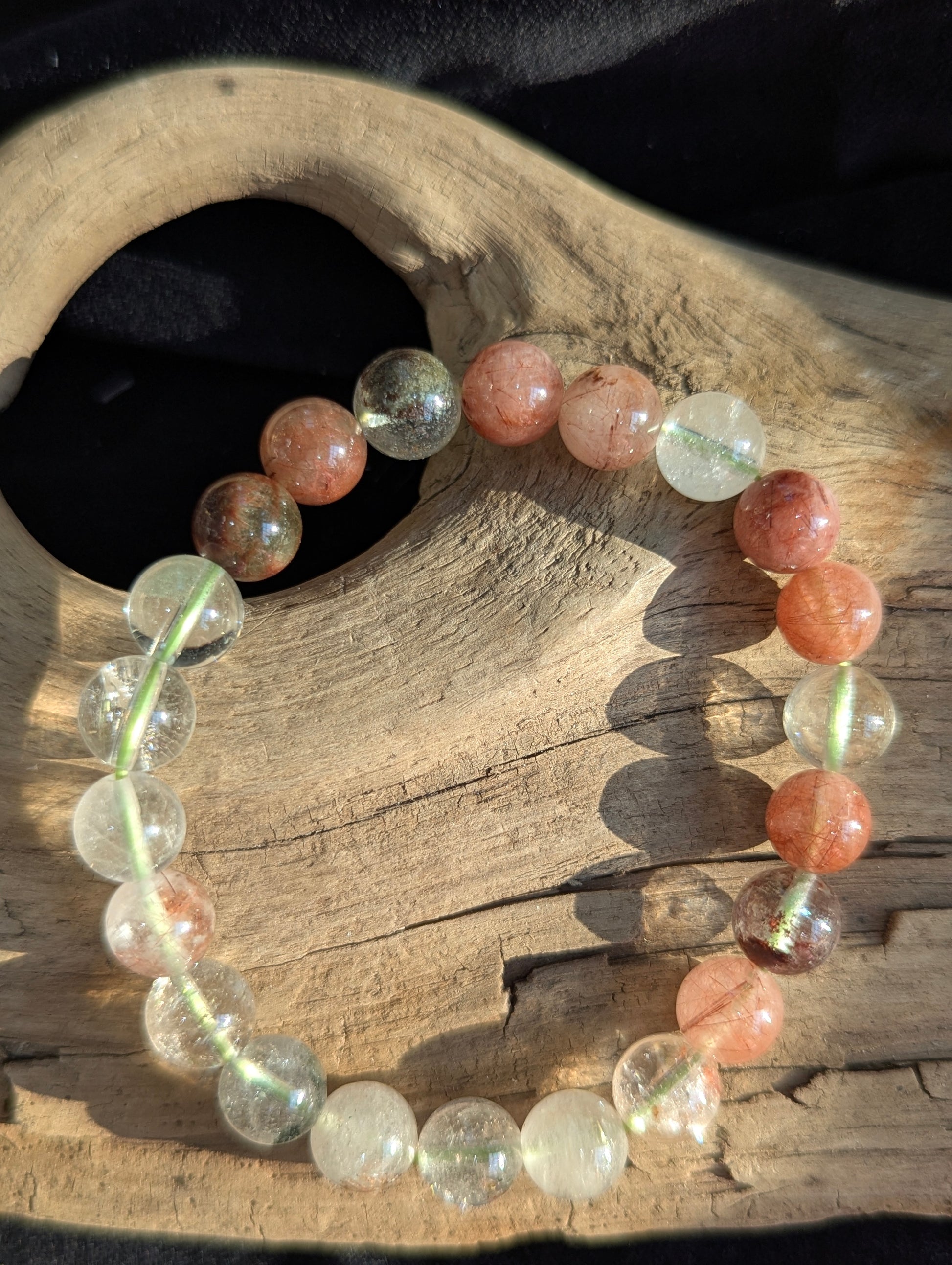 An 8mm Garden Quartz round bead stretch bracelet featuring natural rutile and chlorite inclusions, positioned on a neutral presentation surface.