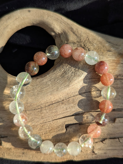 An 8mm Garden Quartz round bead stretch bracelet featuring natural rutile and chlorite inclusions, positioned on a neutral presentation surface.