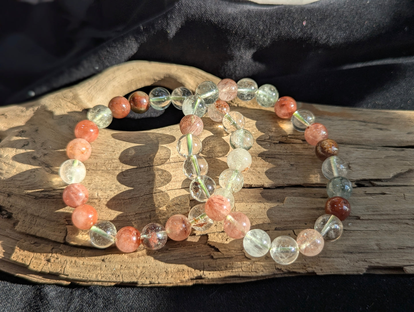 An 8mm Garden Quartz round bead stretch bracelet featuring natural rutile and chlorite inclusions, positioned on a neutral presentation surface.