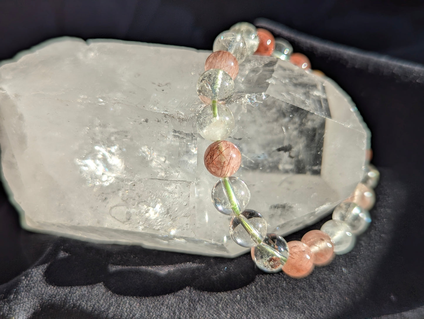 Premium 8mm Garden Quartz and Rutile beaded stretch bracelet worn on the wrist to demonstrate its 17cm (6.69") circumference scale.