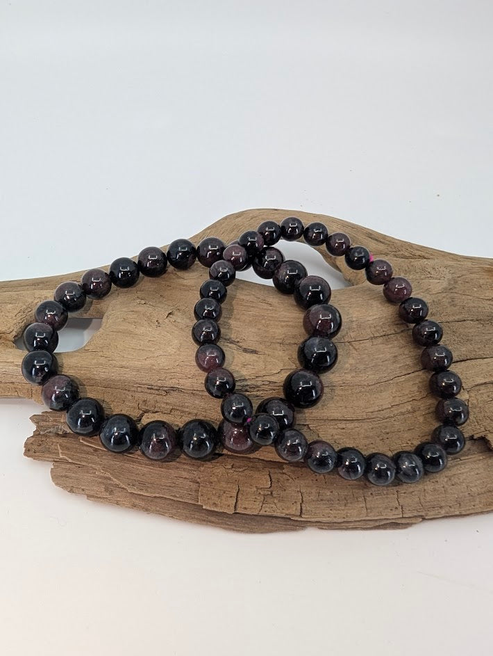 6 mm and 8 mm Garnet with Astrophyllite bracelets showing deep red tone