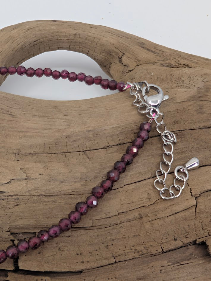 Close-up of faceted garnet beads showing rich wine-red color