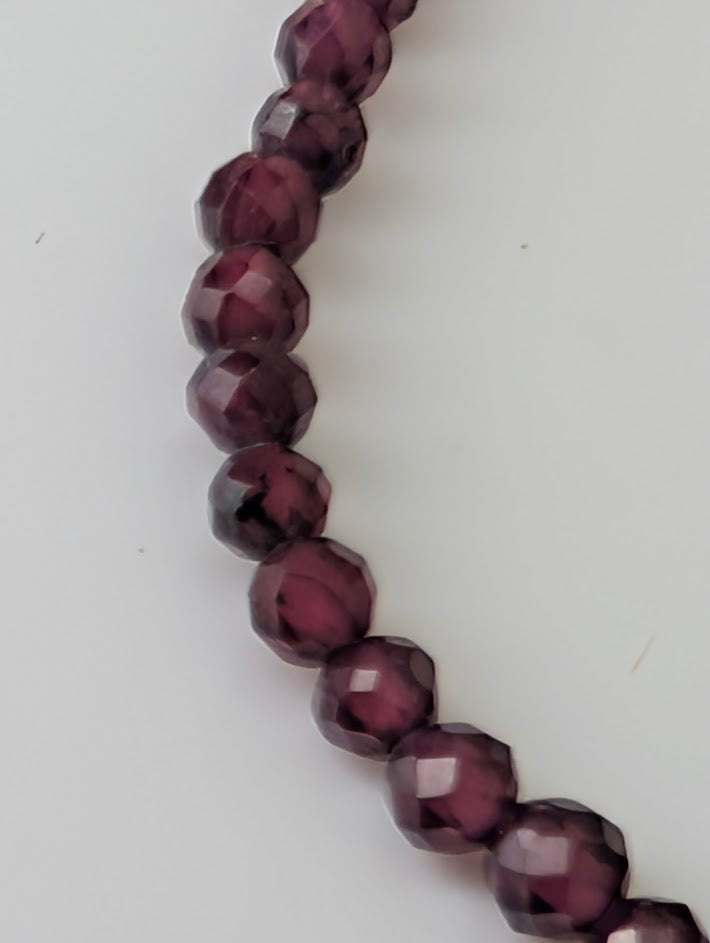 Detailed view of garnet beads with mirror-like polish