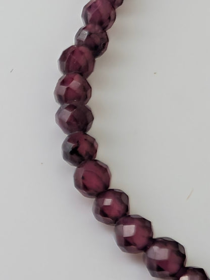 Detailed view of garnet beads with mirror-like polish