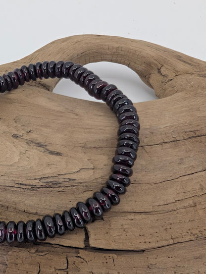 Close-up of garnet rondelles showing glossy luster and red undertone