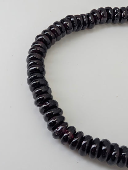 Detail of natural garnet beads with minimal inclusions and high polish