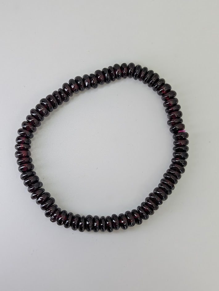Studio view of 5.5 mm garnet heishi bracelet in circular layout