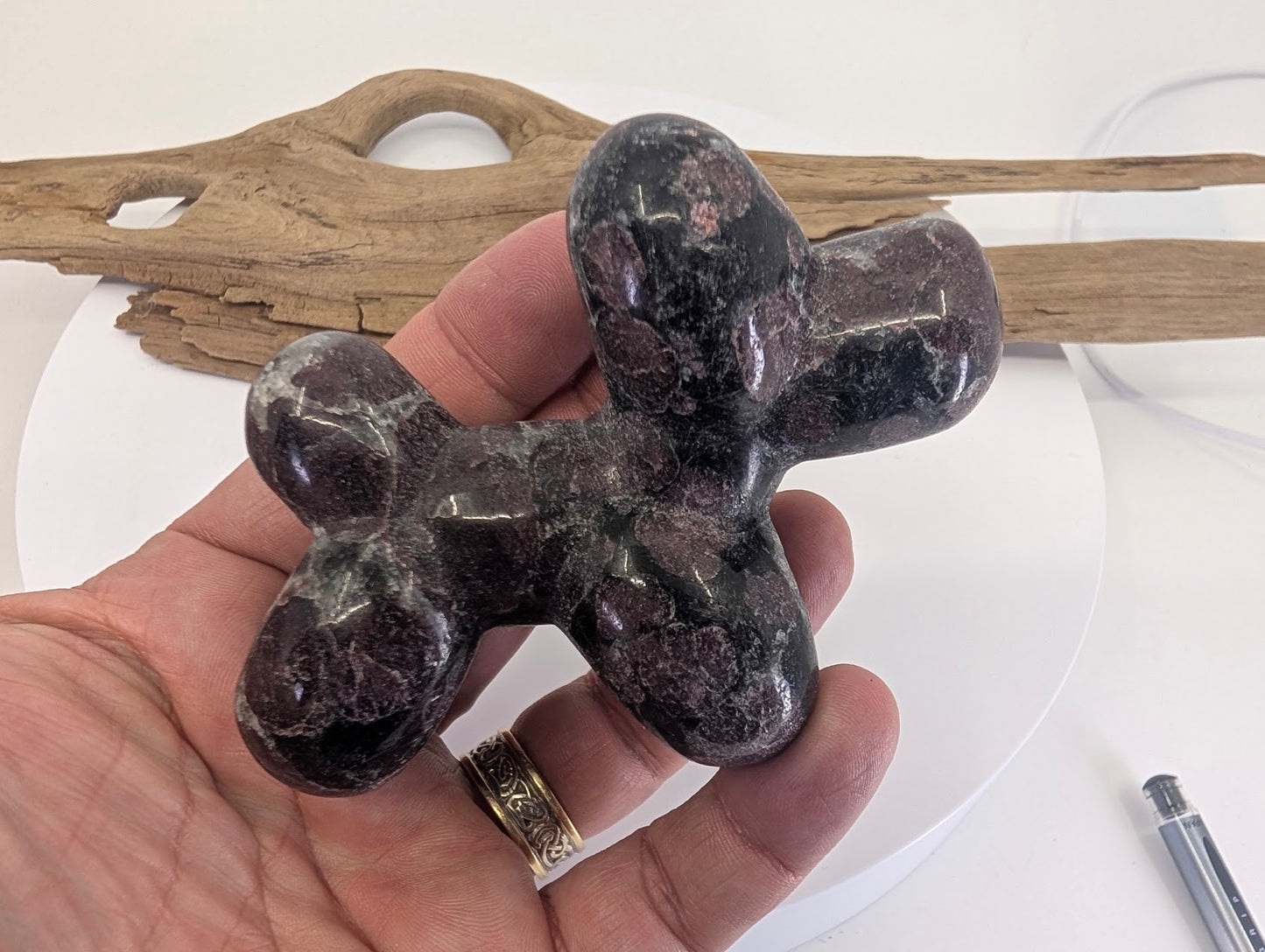 Hand-held view of Garnet in Matrix balloon dog A providing scale and showing the high-polish finish.