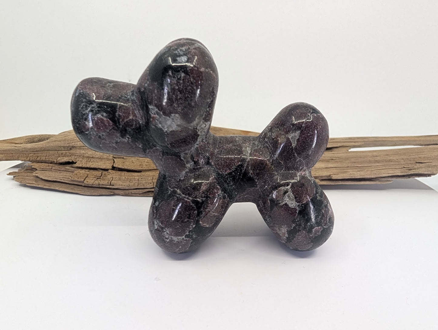 Side profile of Almandine Garnet in Matrix balloon dog specimen A from Brazil.