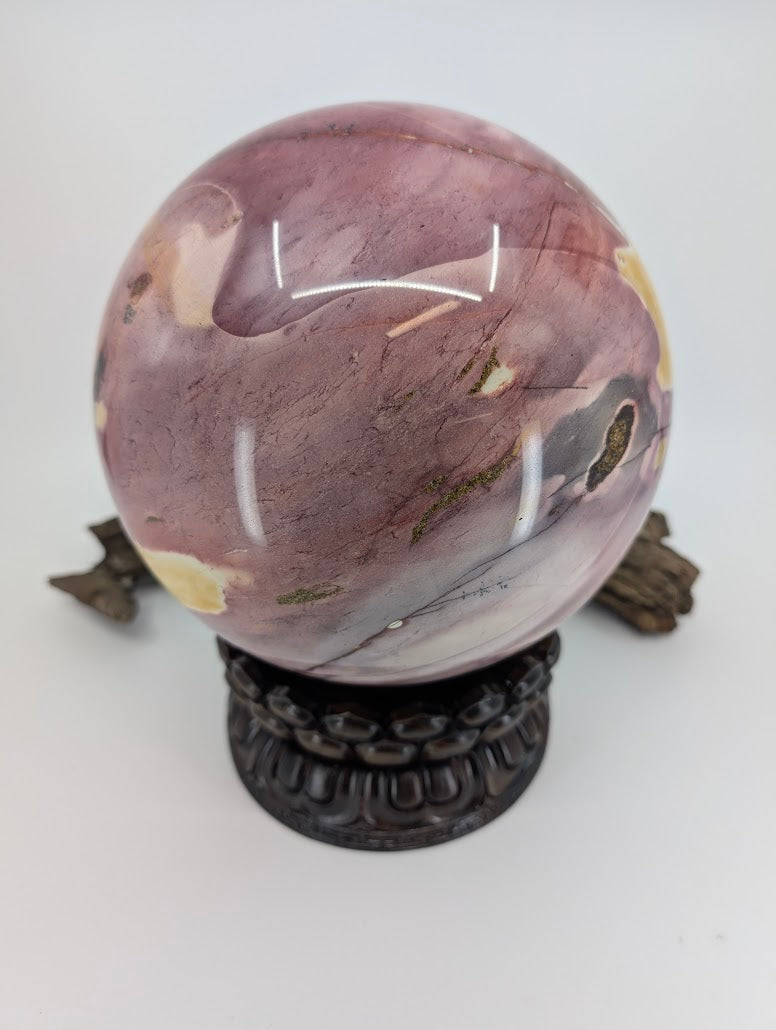 A 19cm Mookaite sphere showing the geological transition between matte yellow sediment and glossy purple chert.