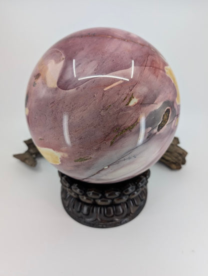 A 19cm Mookaite sphere showing the geological transition between matte yellow sediment and glossy purple chert.