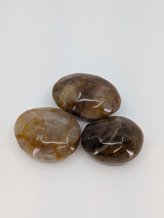 Golden Healer Quartz palm stone with translucent quartz and golden iron oxide inclusions, polished natural stone front view