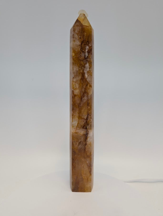 Side profile of Brazilian Golden Healer Quartz Tower under light