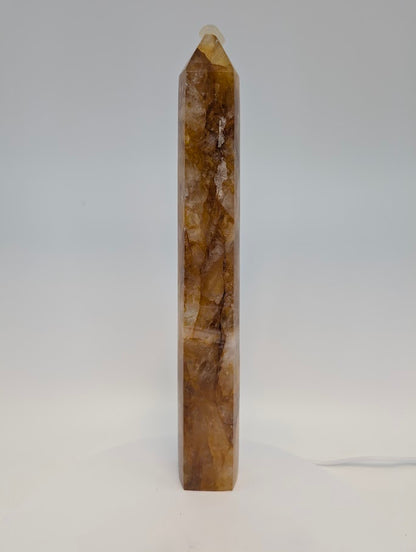 Side profile of Brazilian Golden Healer Quartz Tower under light