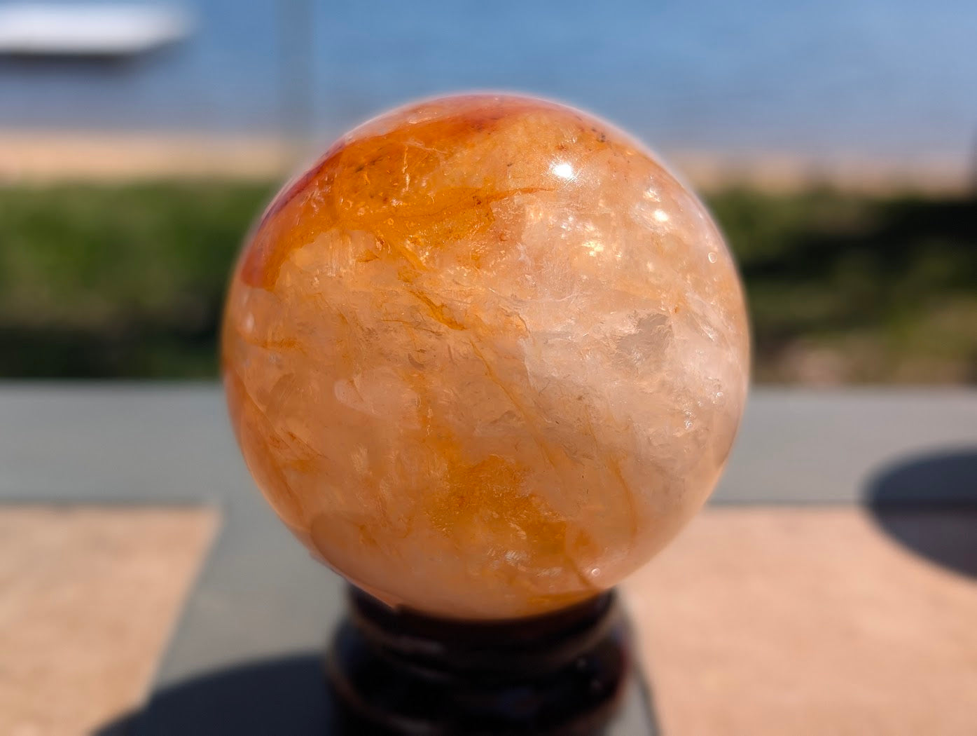 Exact-piece Golden Healer (ferruginous quartz) sphere from Brazil. 63mm variant GHS-05 showing swirling amber and golden-yellow limonite inclusions.