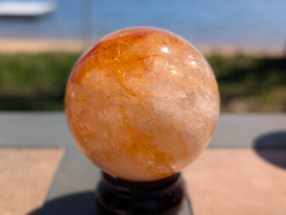 Exact-piece Golden Healer (ferruginous quartz) sphere from Brazil. 63mm variant GHS-05 showing swirling amber and golden-yellow limonite inclusions.