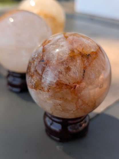 Close-up of Golden Healer quartz sphere GHS-03 highlighting distinct separation of clear and ferruginous zones.