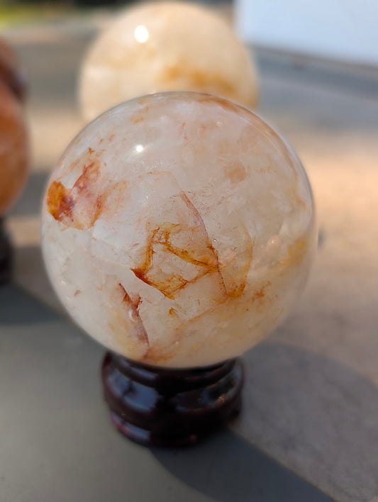 Close-up of Golden Healer quartz sphere GHS-01 highlighting the sweeping zone of highly transparent quartz base.