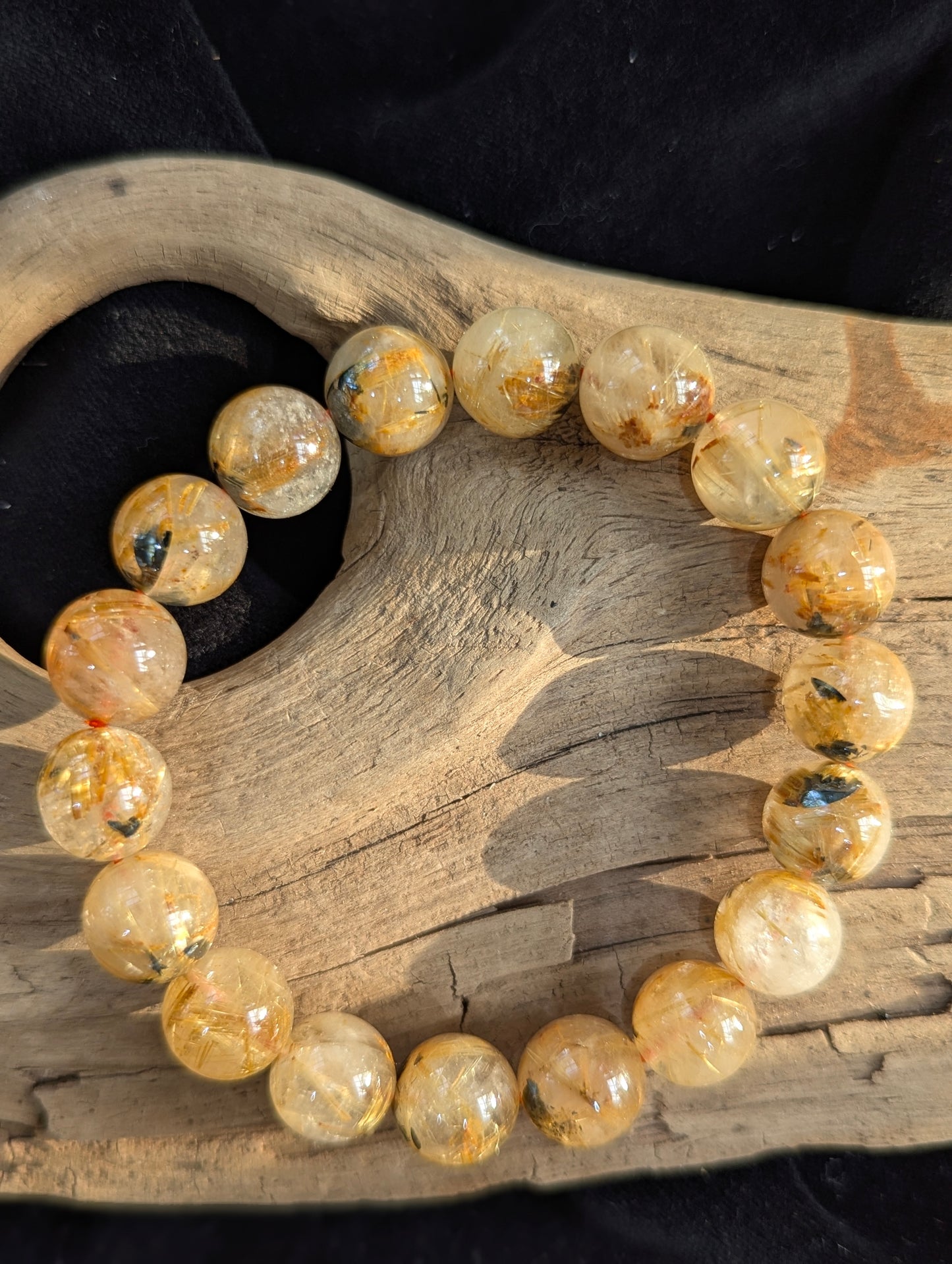 A premium 12mm Golden Rutilated Quartz bracelet from Brazil, featuring thick, densely packed golden rutile needles suspended in highly transparent quartz.