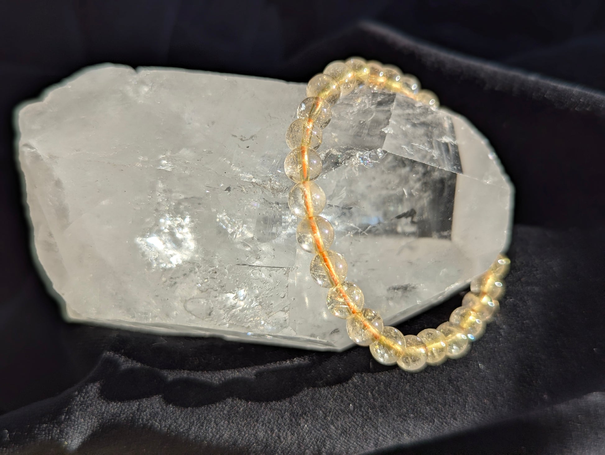 Premium 6mm Golden Rutilated Quartz beaded stretch bracelet worn on the wrist to demonstrate its 17cm circumference scale and continuous mineral profile under balanced lighting.