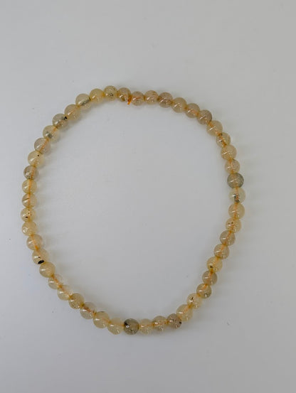 Clear quartz bracelet with golden rutile inclusions, 4 mm size