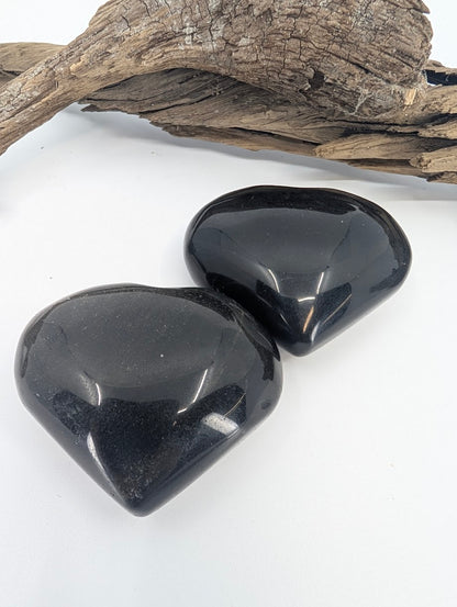 Pair of Golden Sheen Obsidian hearts showing black glass and subtle gold flash.